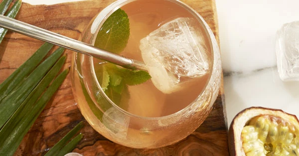 Close-up of cocktail with passion fruit and lime.